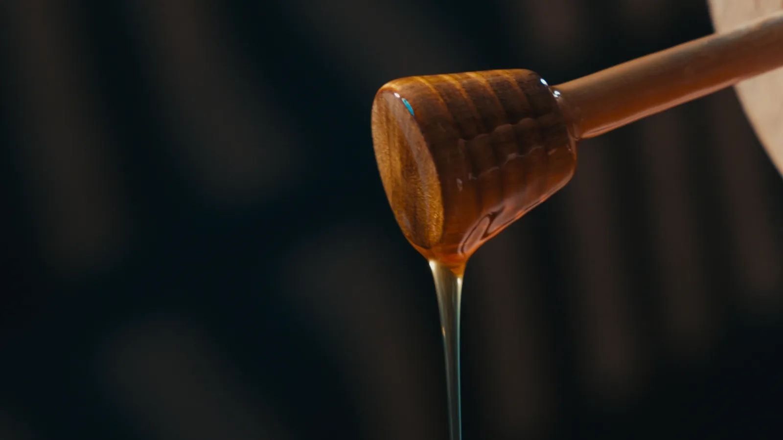 Honey running off a wooden dipper