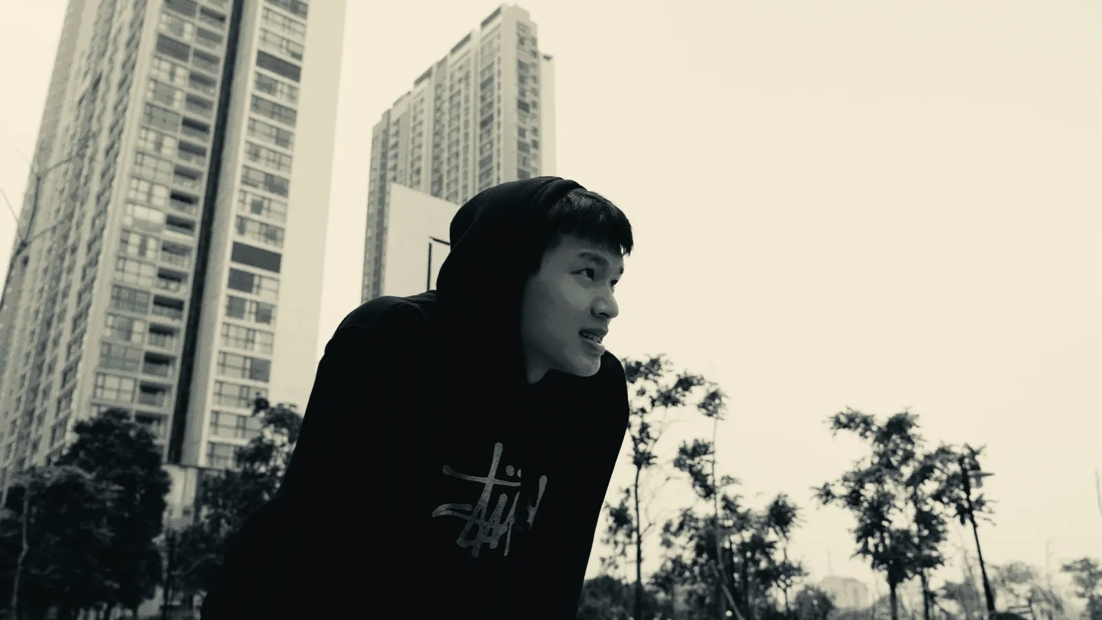 Hooded portrait in front of the towers