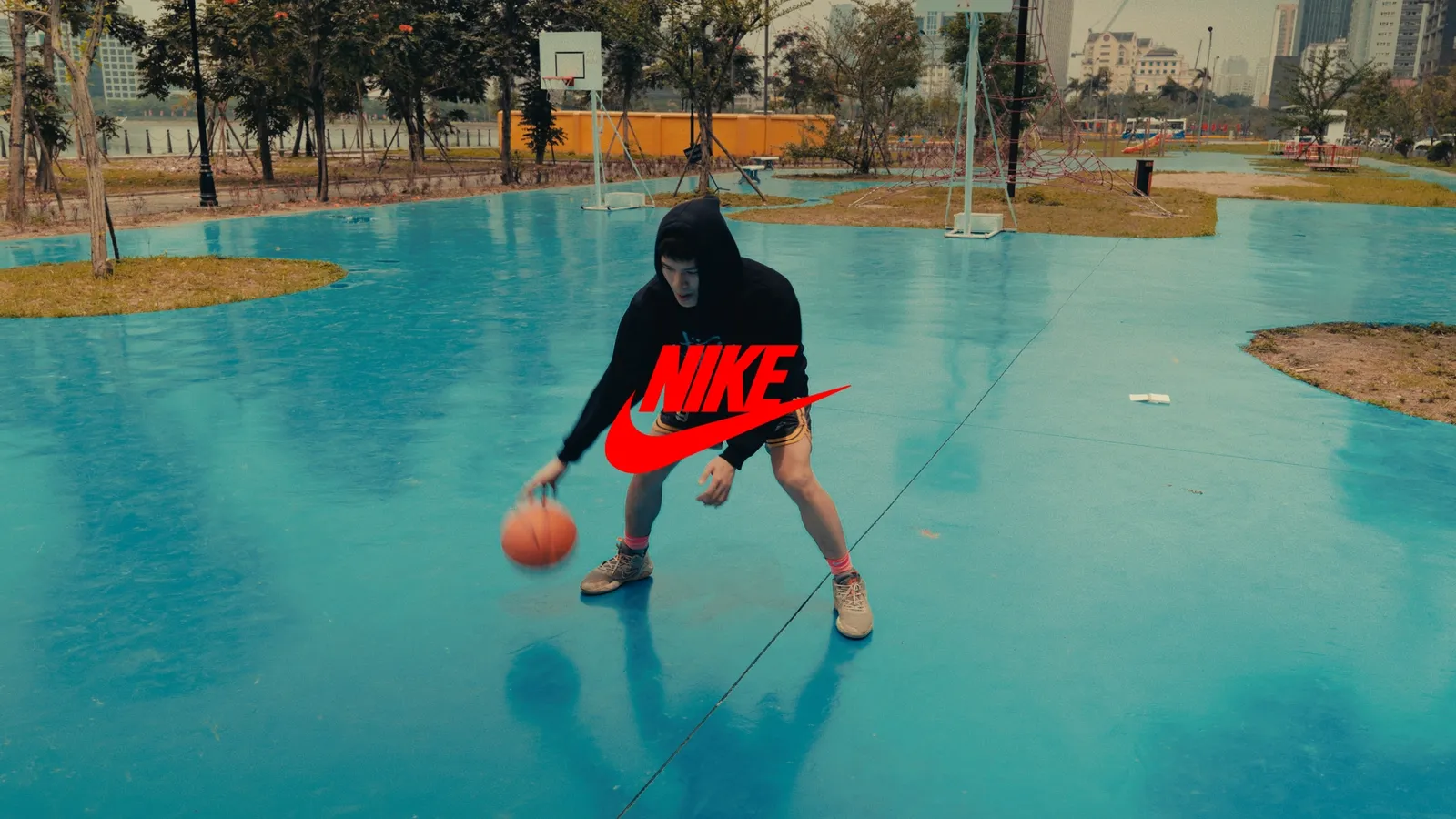 Dribbling in a black hoodie, the Nike swoosh in red